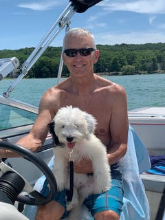 Rob Meyer on a boat with his dog, a volunteer for GLA